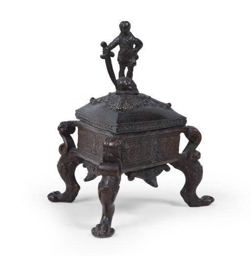 A TRIANGULAR BRONZE INKWELL