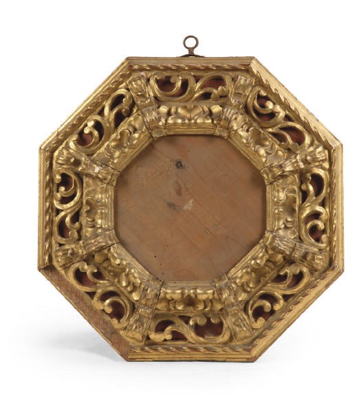 A SPANISH CARVED AND PIERCED GILTWOOD OCTAGONAL FRAME