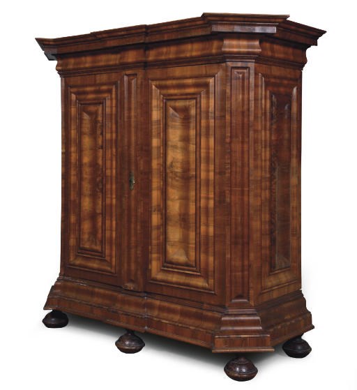 A GERMAN WALNUT CUPBOARD 'WELLENSCHRANK'
