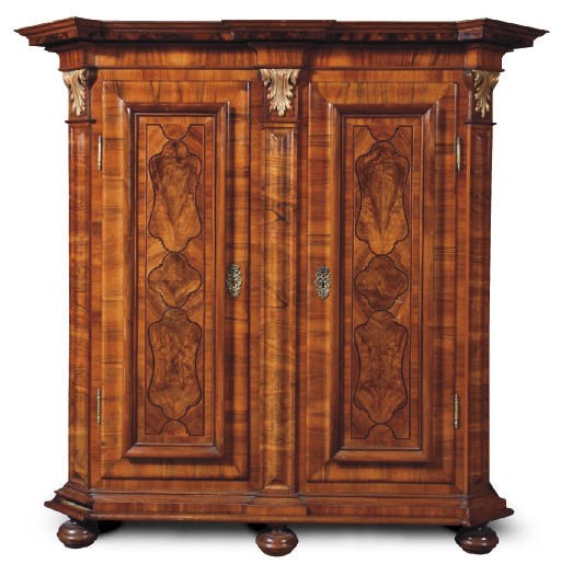 AN AUSTRIAN PARCEL-GILT WALNUT, FIGURED-WALNUT AND AMARANTH CUPBOARD