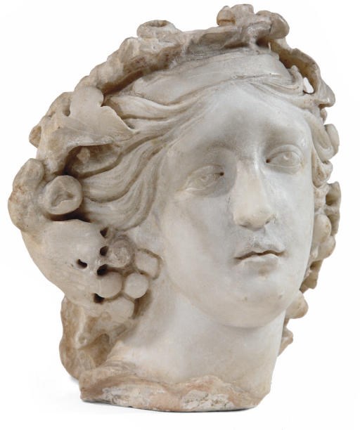 A FRAGMENTARY CARVED MARBLE HEAD OF A MAIDEN