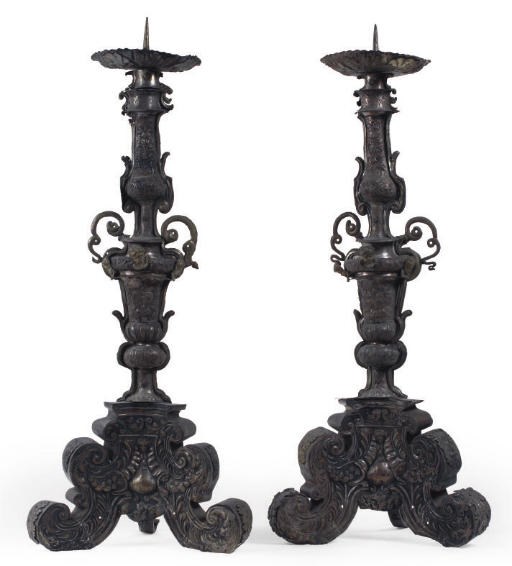 A PAIR OF AUSTRIAN SILVERED REPOUSSE BRASS PRICKET CANDLESTICKS