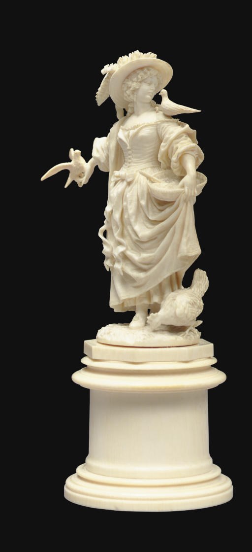 A FRENCH IVORY FIGURE OF A LADY FEEDING BIRDS**