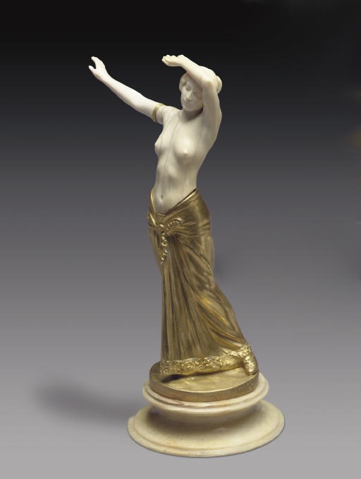 A FRENCH GILT-BRONZE AND IVORY FIGURE OF A DANCER**