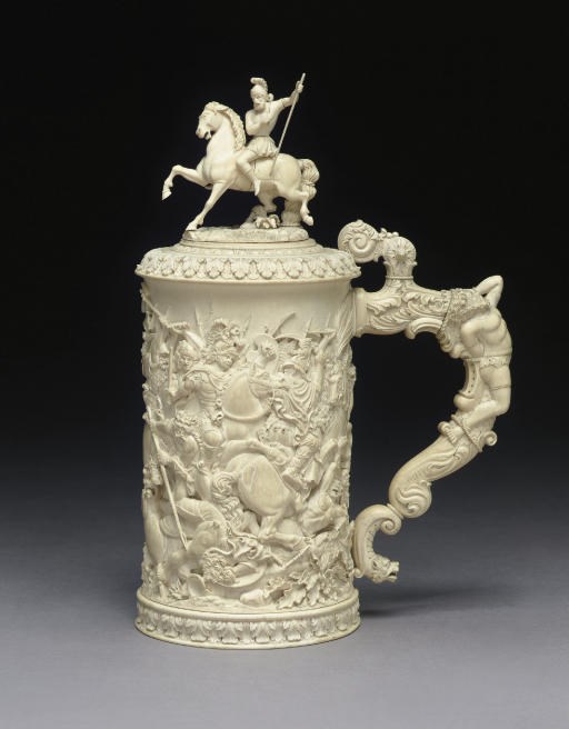 A GERMAN CARVED IVORY TANKARD**