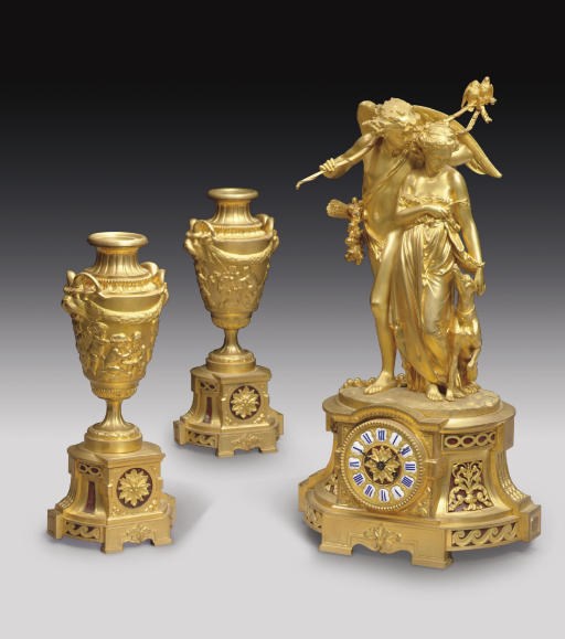 A FRENCH ORMOLU AND GRIOTTE ROUGE MARBLE THREE-PIECE CLOCK GARNITURE