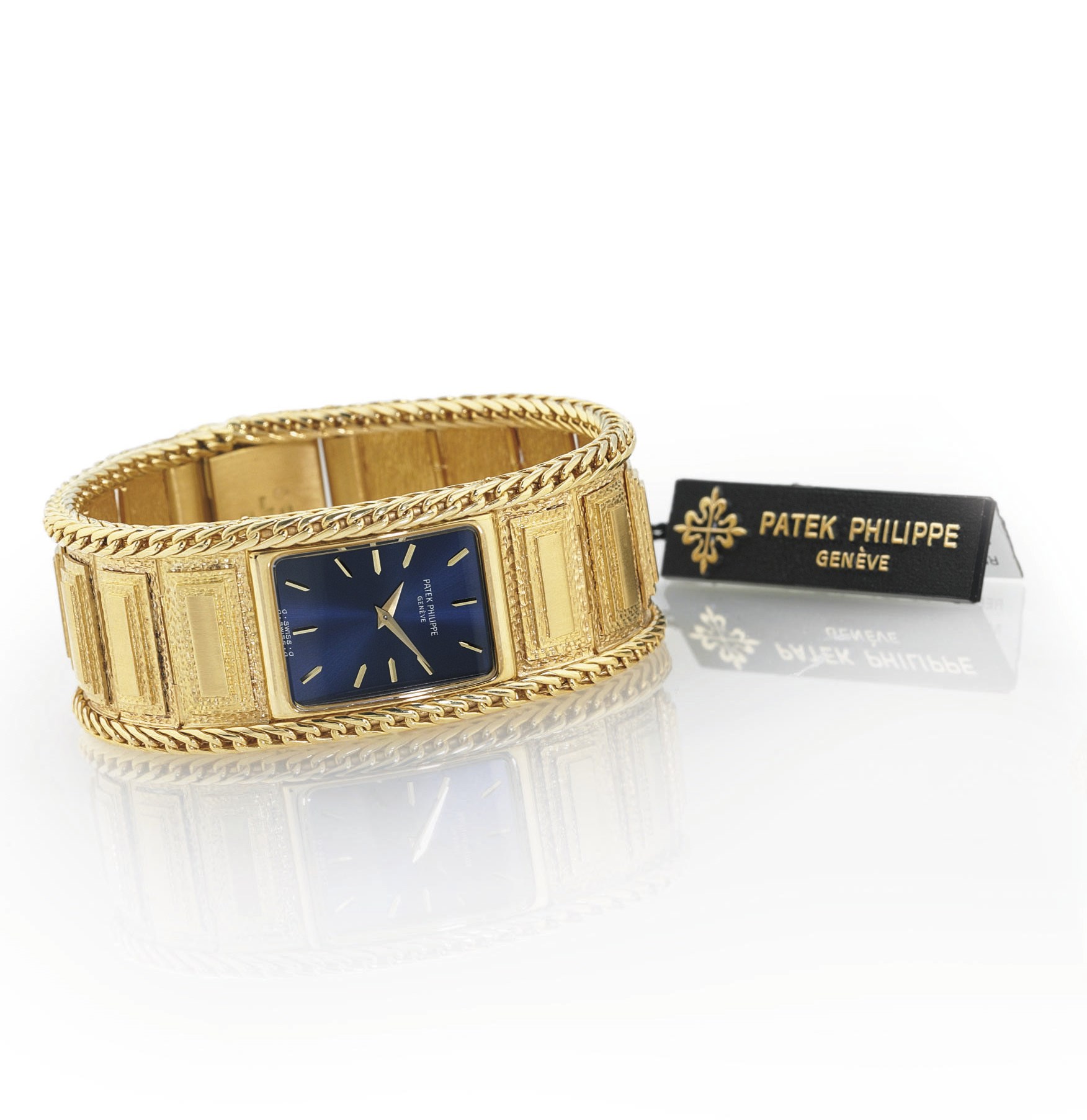 PATEK PHILIPPE. AN EXTREMELY FINE, RARE AND HEAVY 18K GOLD RECTANGULAR BRACELET WATCH