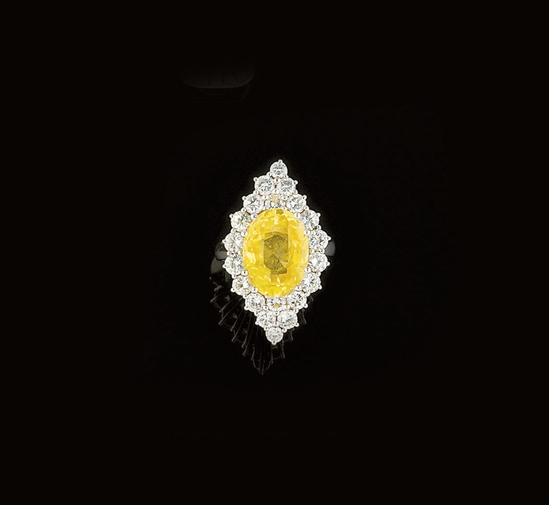 A yellow sapphire and diamond ring