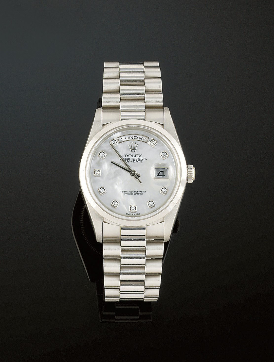 A platinum, mother-of-pearl and diamond automatic day-date wristwatch, by Rolex