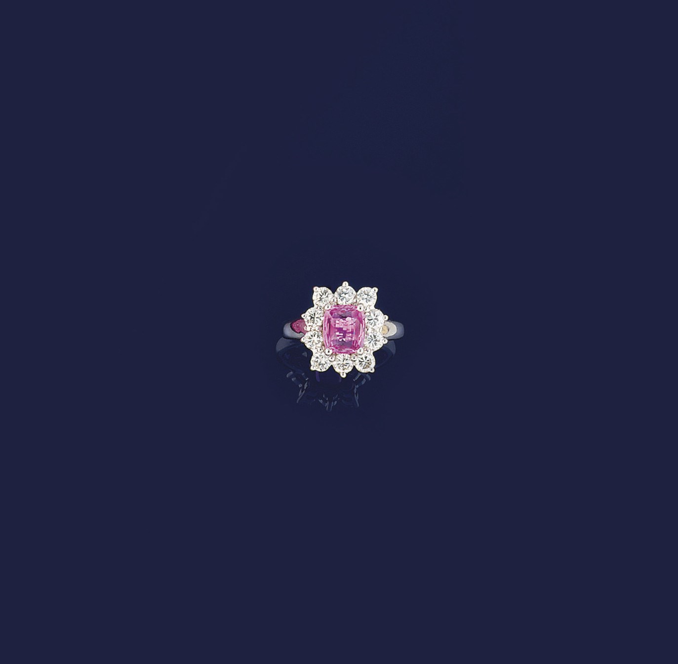 A pink sapphire and diamond cluster ring