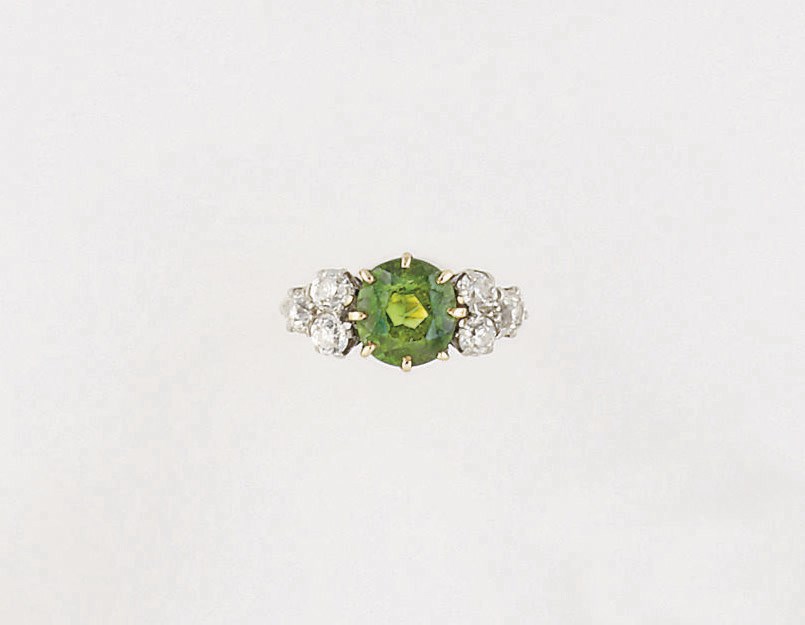 An early 20th century demantoid garnet and diamond ring