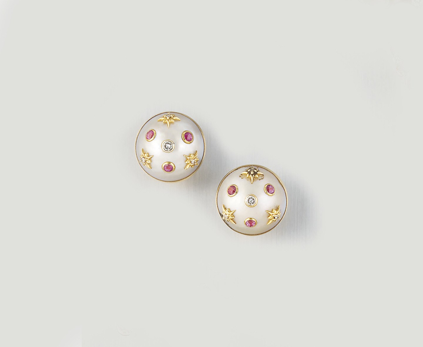 A PAIR OF MABÉ CULTURED PEARL, DIAMOND AND PINK SAPPHIRE EARCLIPS, BY SEAMAN SCHEPPS
