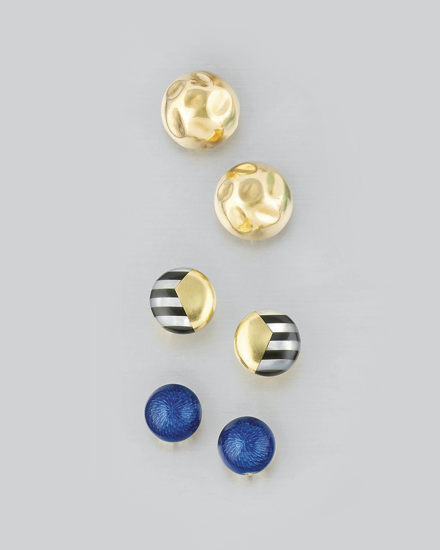 Three pairs of circular design earrings