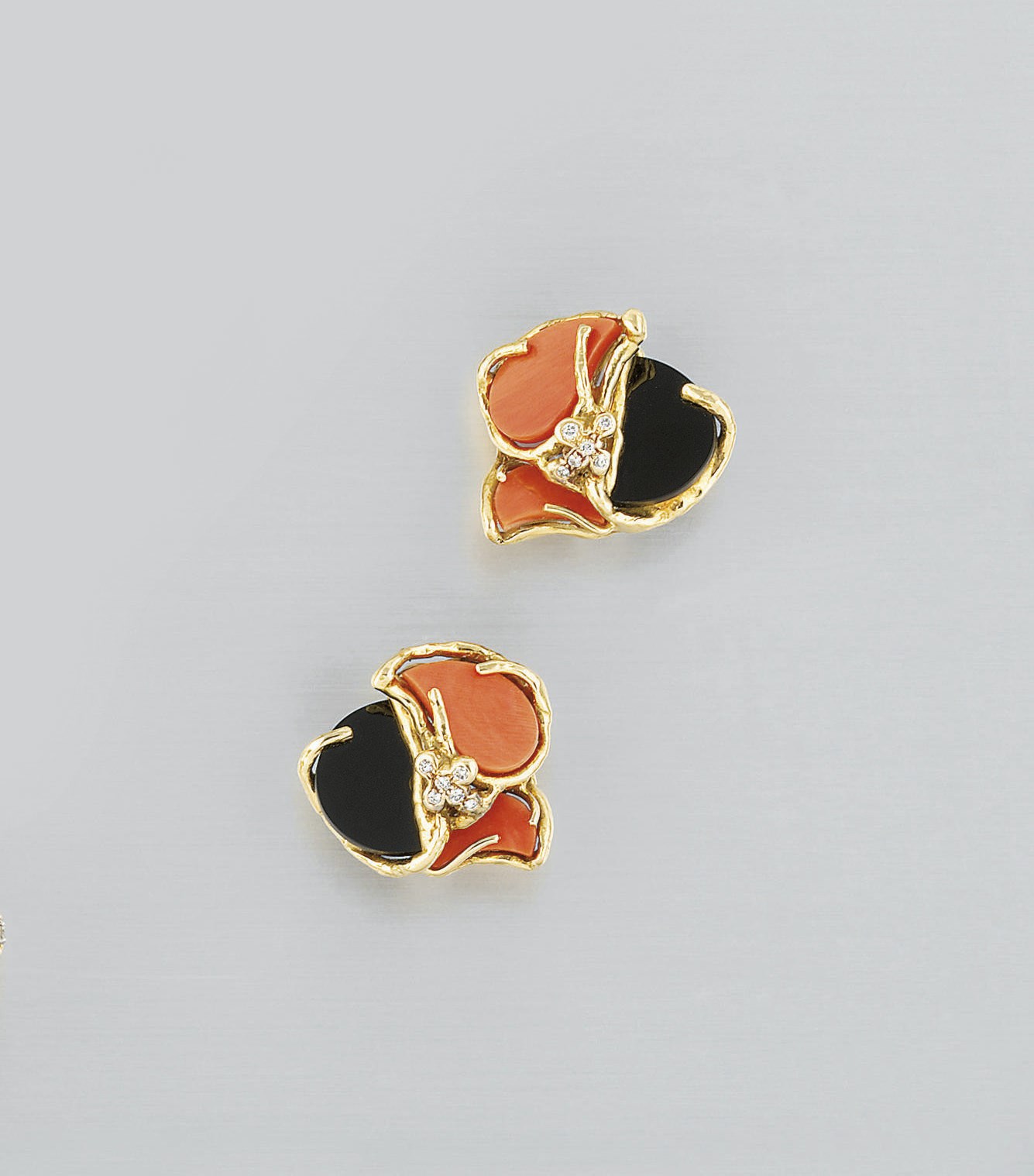 A pair of coral, onyx and diamond earclips, by Chaumet
