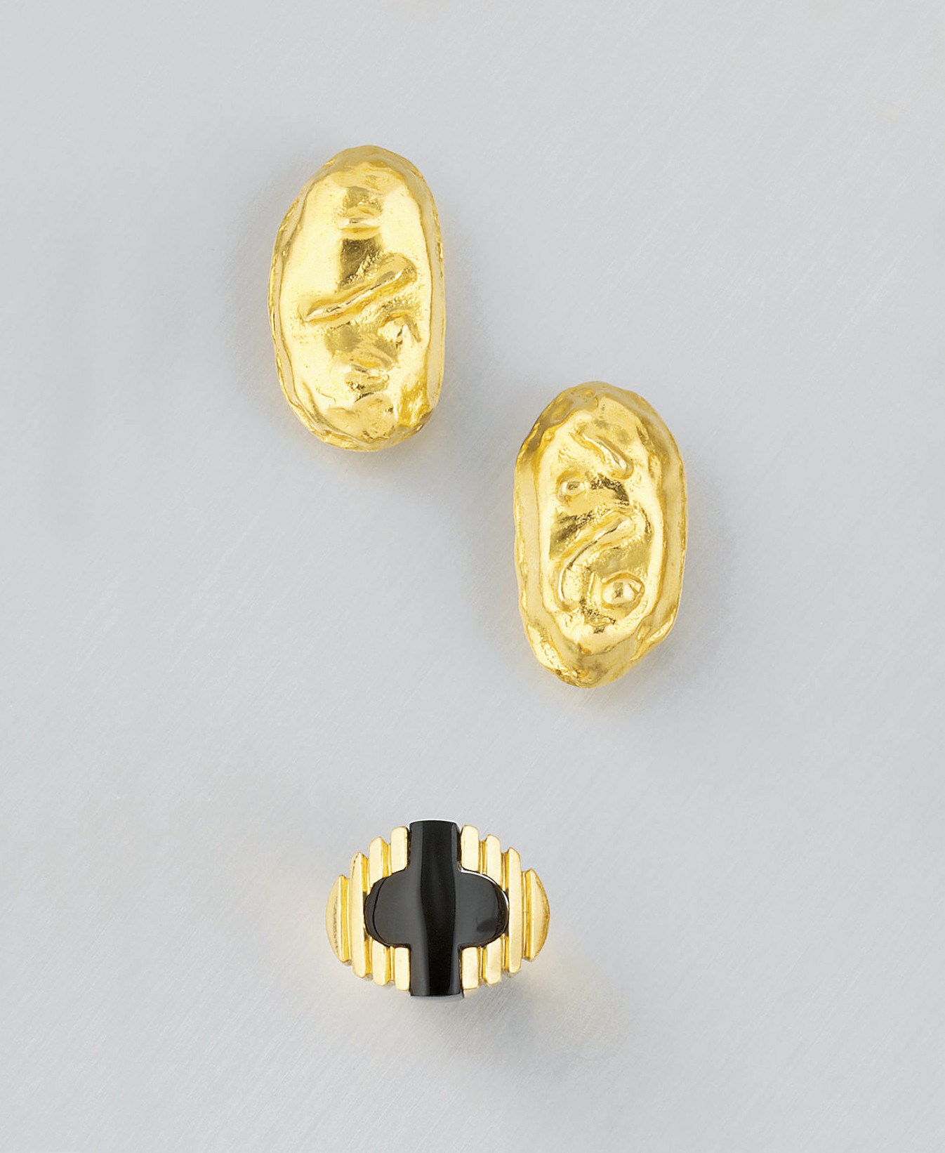A pair of earclips, by Jean Mahie and an onyx ring, by A.Cippulo for  Cartier