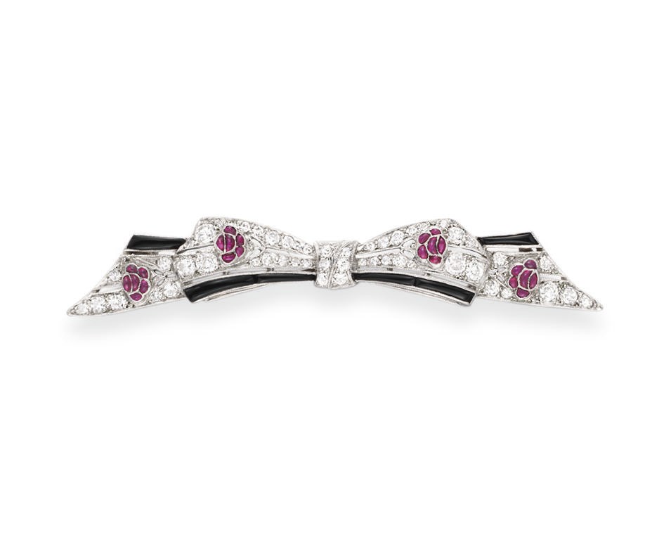 AN ART DECO RUBY, ONYX AND DIAMOND BROOCH