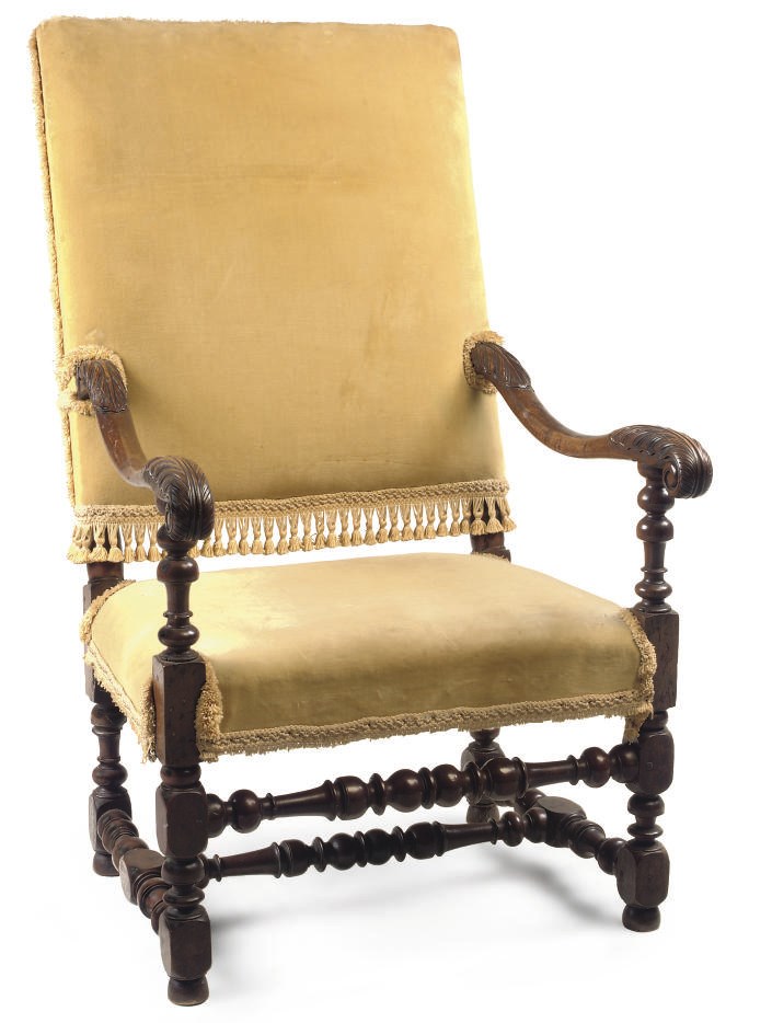 A VICTORIAN CARVED AND TURNED WALNUT ARMCHAIR