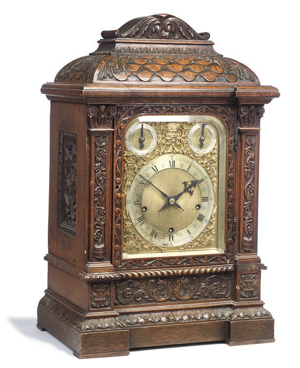 A German carved oak quarter-chiming bracket clock