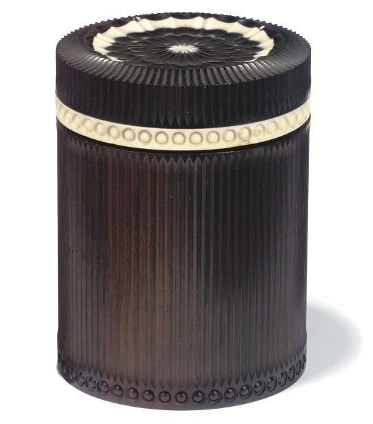 AN ANGLO INDIAN EBONY AND IVORY CYLINDRICAL BOX