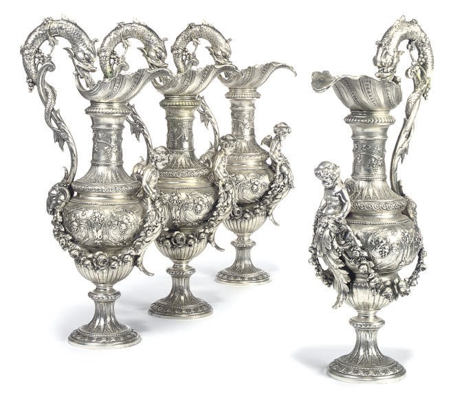 A SET OF FOUR SILVERED SPELTER EWERS