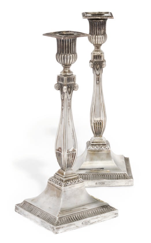 A MATCHED PAIR OF EDWARDIAN SILVER CANDLESTICKS IN THE ADAM STYLE