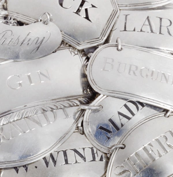 A GROUP OF THIRTEEN SILVER WINE LABELS