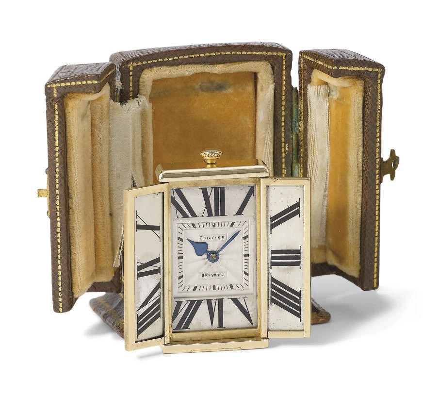 Cartier. A fine and unusual 18K gold and enamel 8-day miniature travel clock with fitted box