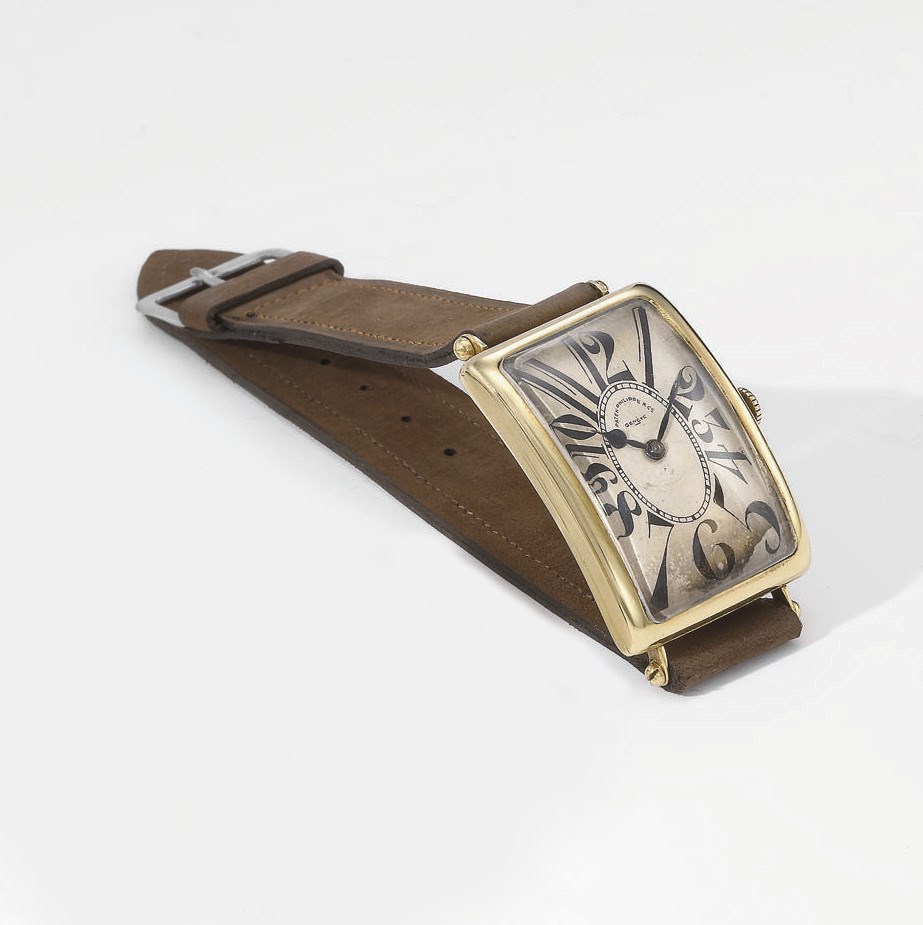 Patek Philippe. A very fine and rare 18K gold rectangular curved wristwatch with "explosion" numerals