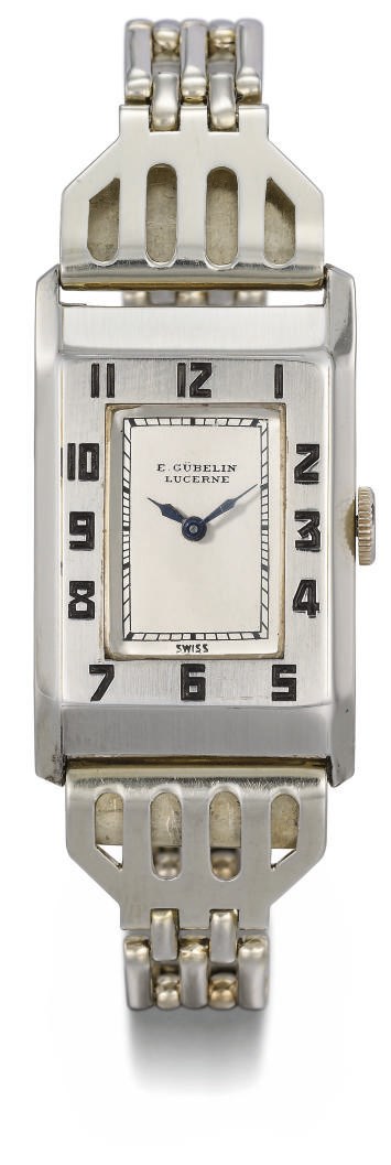 Gübelin. An unusual 18K white gold rectangular hinged wristwatch with stainless steel bracelet
