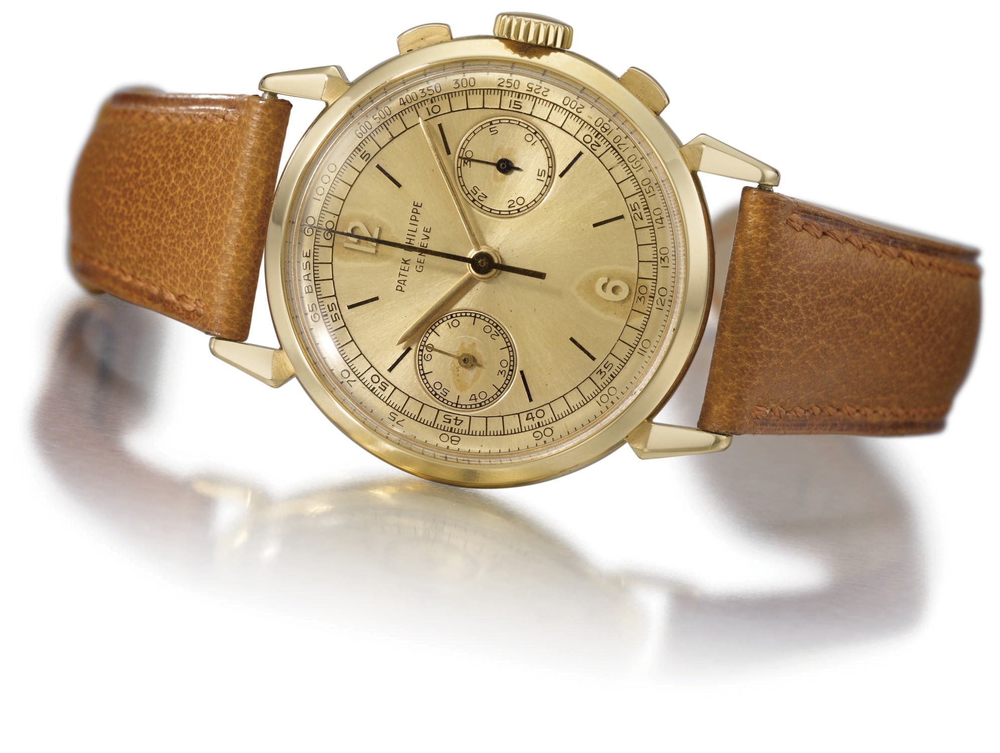 Patek Philippe. A fine and unusual 18K gold chronograph wristwatch with champagne "soleil" dial