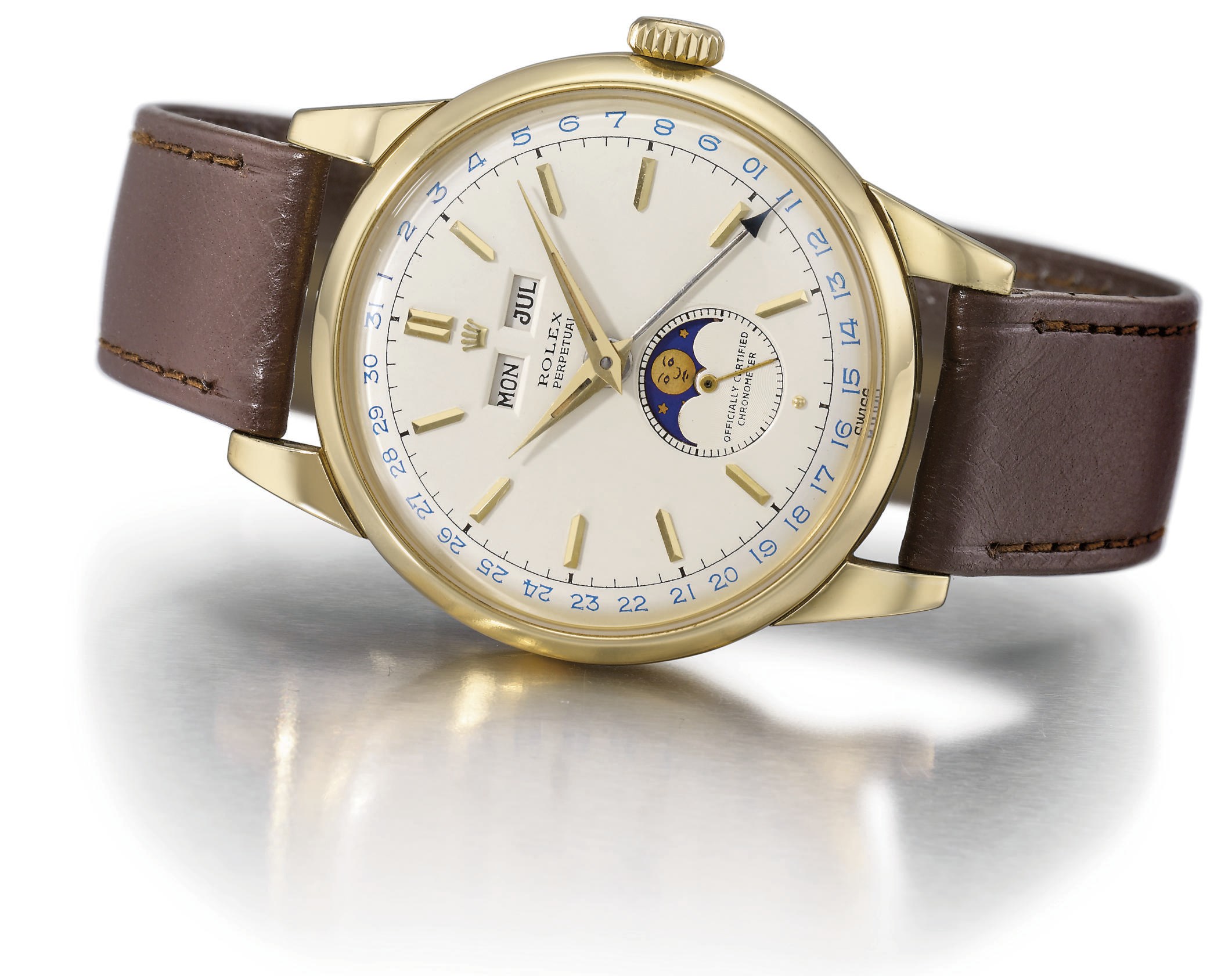 Rolex. A fine and large 18K gold self-winding triple calendar wristwatch with phases of the moon