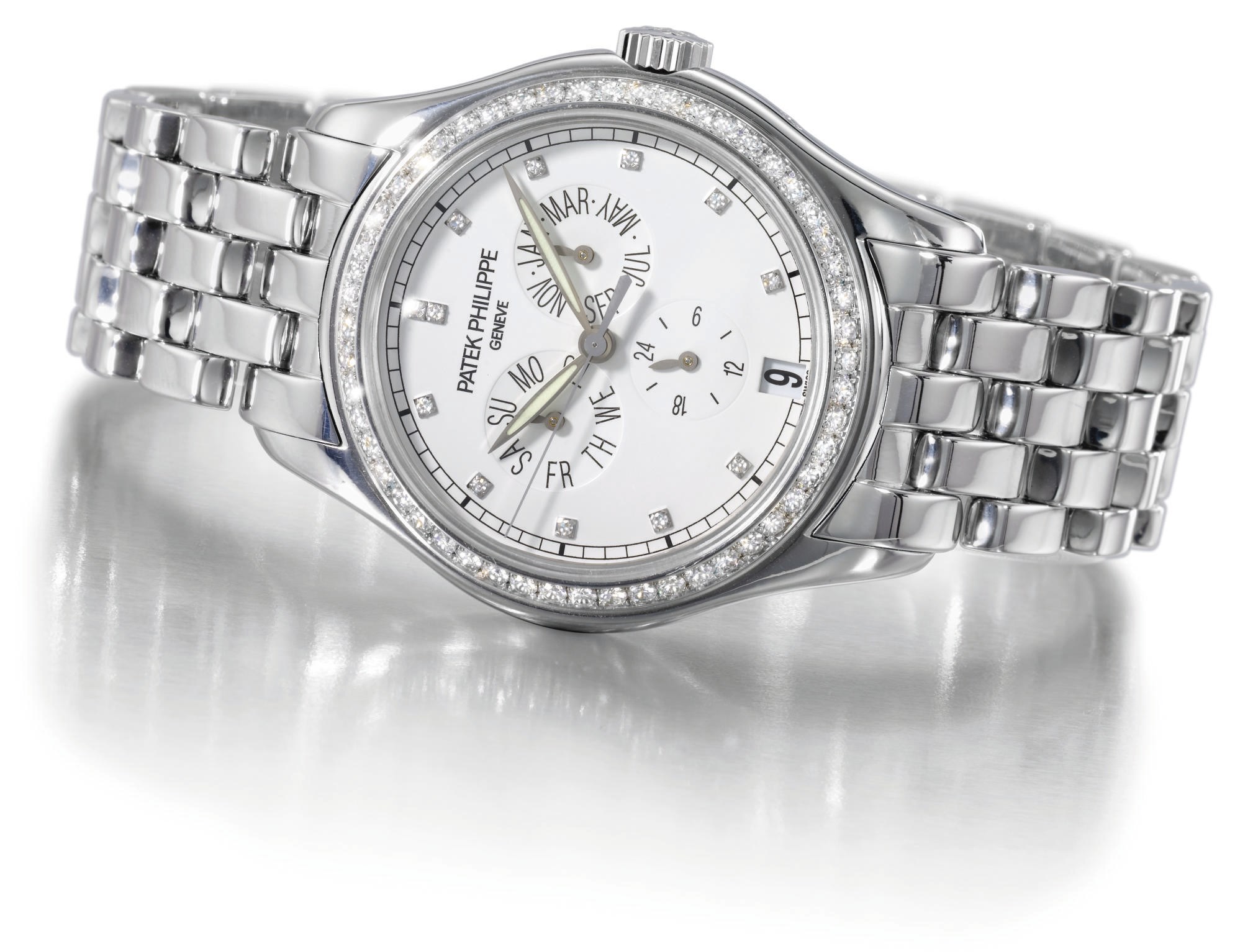 Patek Philippe. A fine and rare 18K white gold and diamond-set self-winding water-resistant annual calendar wristwatch with sweep centre seconds, date and bracelet