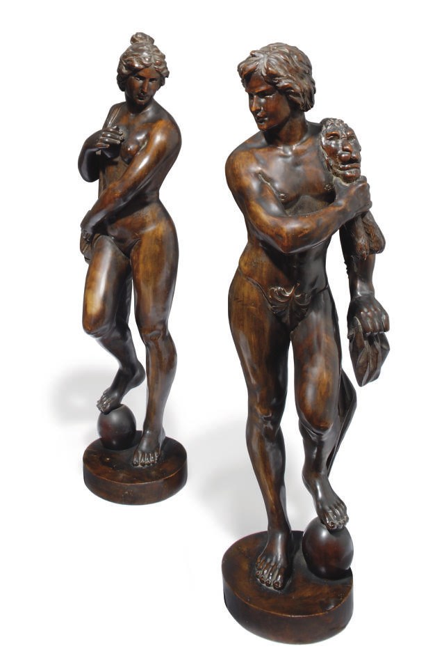 A PAIR OF CARVED WALNUT CLASSICAL FIGURES