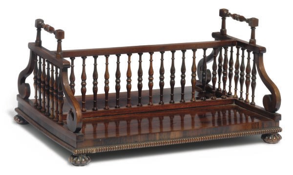 A GEORGE IV ROSEWOOD AND MAHOGANY BOOKTROUGH