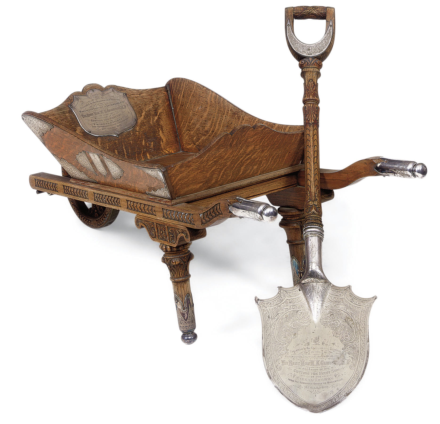 A COMMEMORATIVE OAK SILVER-MOUNTED WHEELBARROW AND SHOVEL