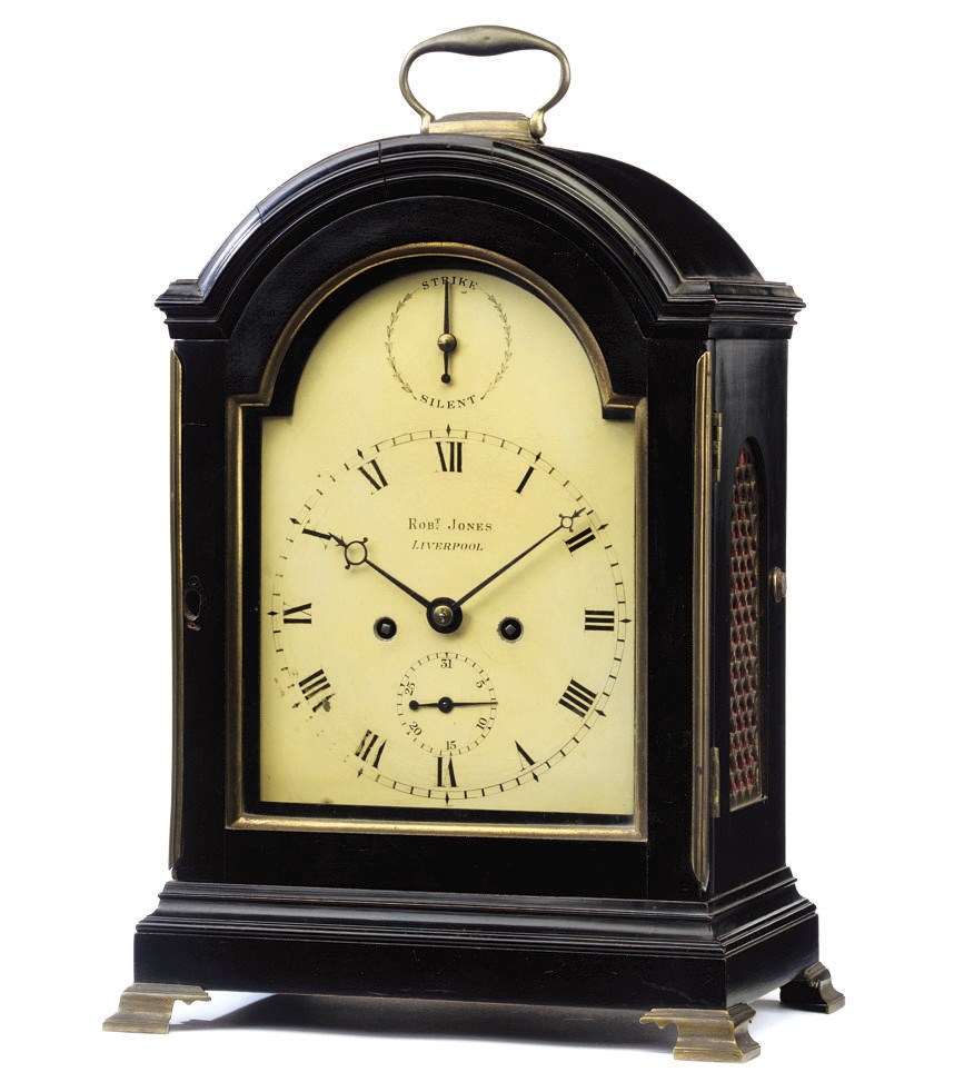 A GEORGE III EBONISED AND BRASS-MOUNTED STRIKING EIGHT DAY TABLE CLOCK