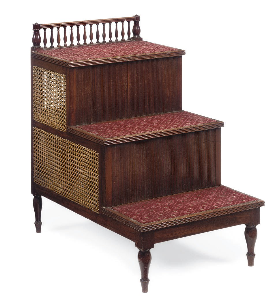 A SET OF LATE REGENCY MAHOGANY AND CANED THREE-TIER BED STEPS