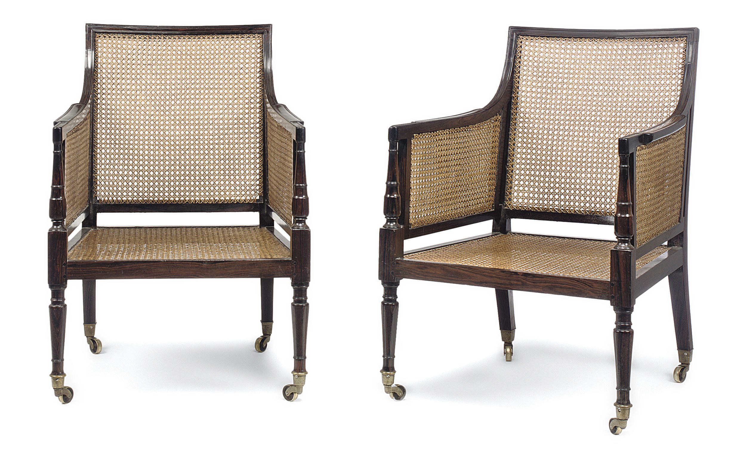 A PAIR OF ANGLO-INDIAN EBONY AND CANED LIBRARY BERGÈRES