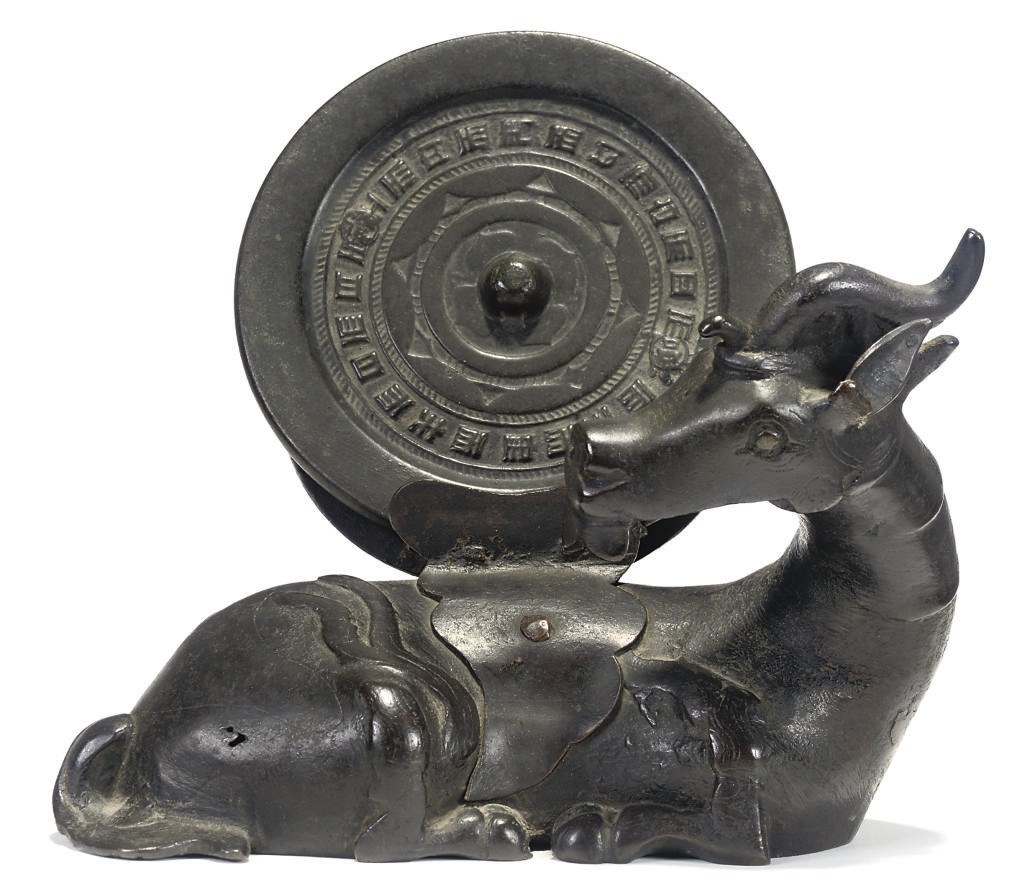 A CHINESE BRONZE CIRCULAR MIRROR AND STAND IN THE FORM OF A RECUMBENT QILIN