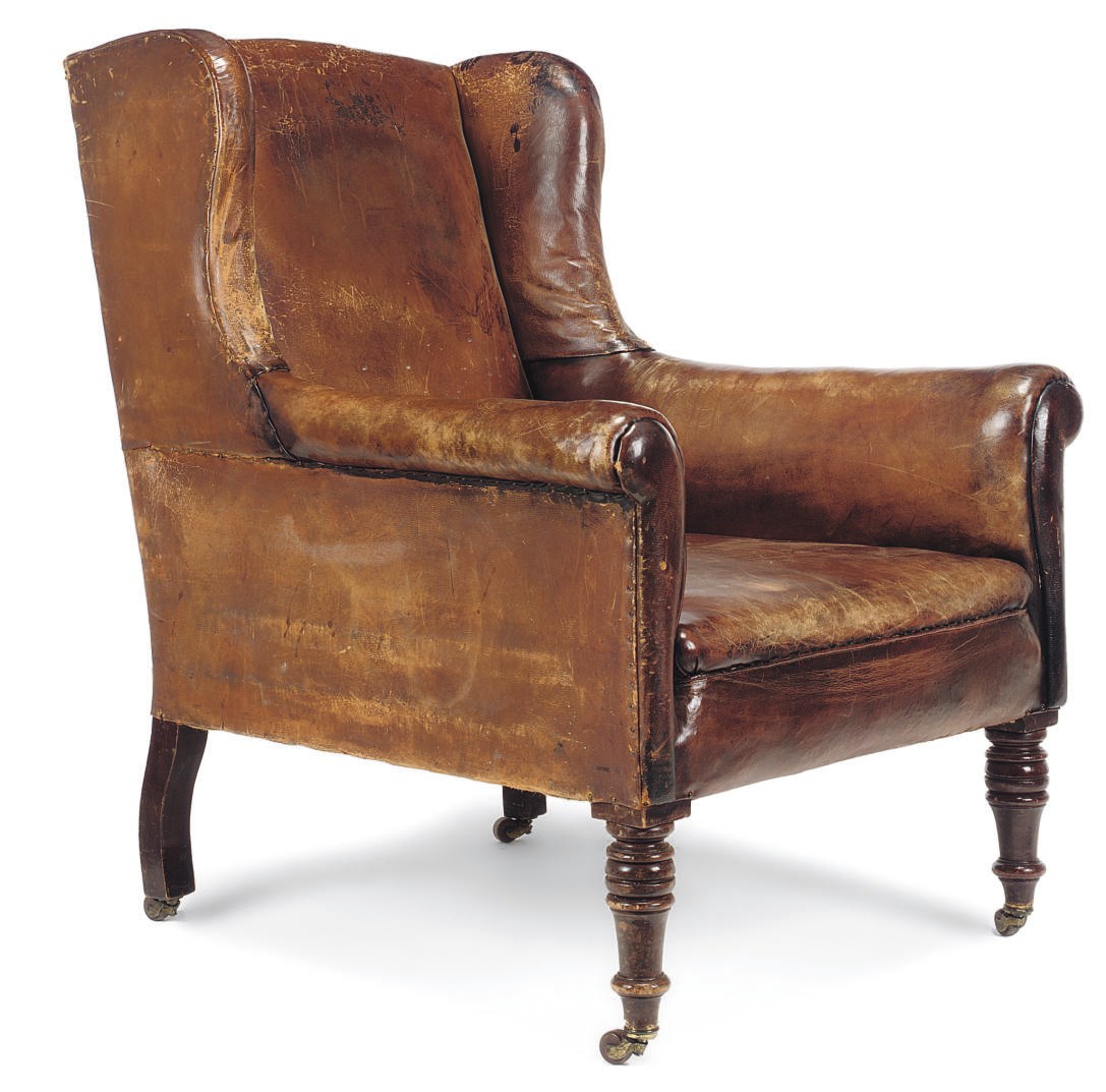 A VICTORIAN WALNUT LIBRARY ARMCHAIR
