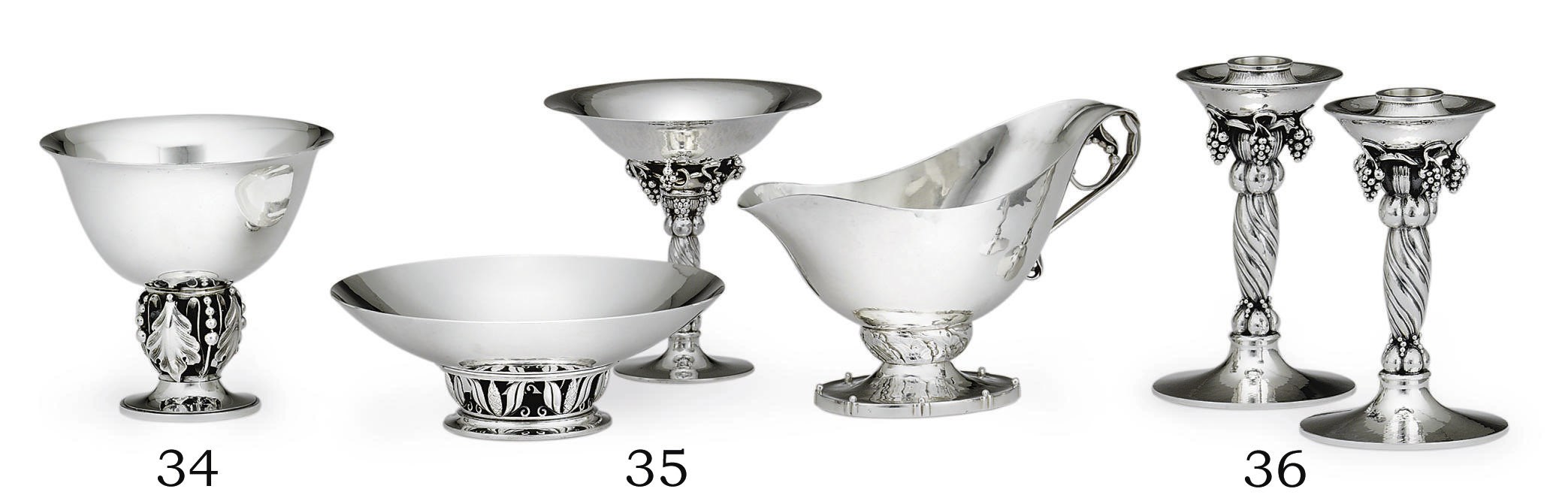 A PAIR OF DANISH SILVER CANDLESTICKS DESIGNED BY GEORG JENSEN