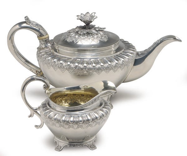 A GEORGE IV SILVER TEAPOT WITH HINGED COVER AND A MILK JUG,**