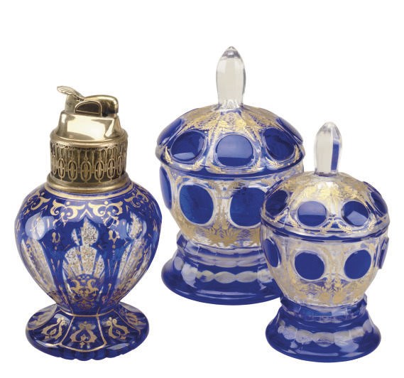 A CONTINENTAL CASED-GLASS TABLE LIGHTER AND AND TWO JARS AND COVERS,