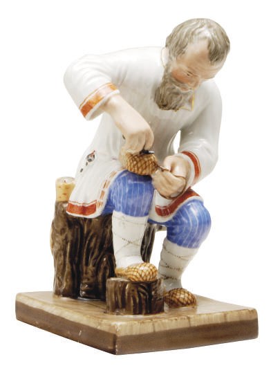 A RUSSIAN PORCELAIN FIGURE OF A COBBLER WORKING AT HIS BENCH,