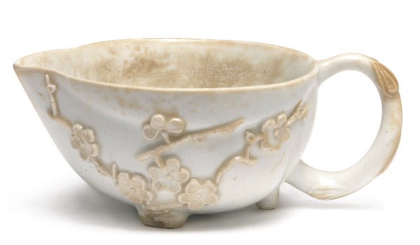 AN ENGLISH PORCELAIN WHITE PEACH-FORM PRUNUS-MOLDED WINE TASTER,