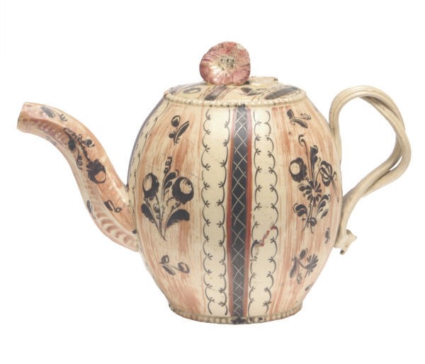 A STAFFORDSHIRE CREAMWARE 'CHINTZ' OVIFORM TEAPOT AND COVER,