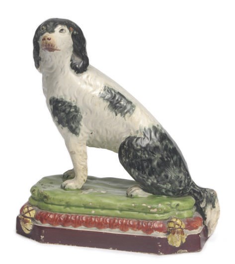 A STAFFORDSHIRE PEARLWARE MODEL OF A SEATED SETTER,