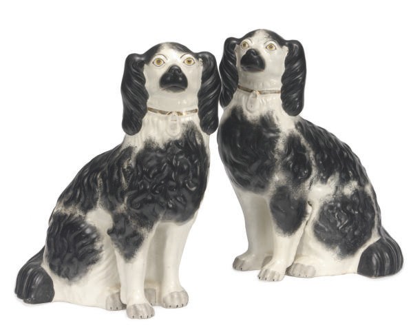 A PAIR OF STAFFORDSHIRE MODELS OF SEATED BLACK AND WHITE SPANIELS,