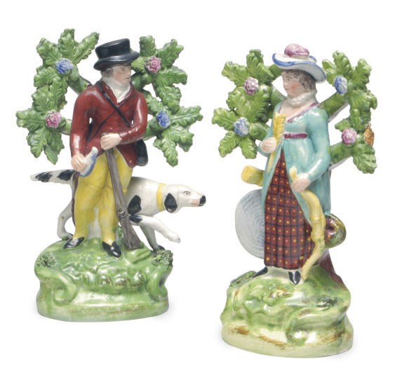 A PAIR OF STAFFORDSHIRE WALTON-TYPE PEARLWARE BOCAGE FIGURES OF COMPANION HUNTERS,