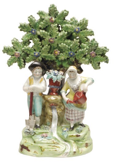 A STAFFORDSHIRE PEARLWARE BOCAGE GROUP OF A GARDENER AND COMPANION,